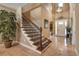 Spacious foyer includes staircase, travertine floors, and natural light at 6302 Anise Dr, Sarasota, FL 34238