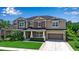 Charming two-story home boasts manicured landscaping, a two-car garage, and a welcoming front porch seating area at 6302 Anise Dr, Sarasota, FL 34238