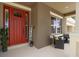 Charming front porch with a bright red door, 'welcome' sign, and seating at 6302 Anise Dr, Sarasota, FL 34238