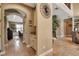 Inviting hallway with neutral tones, arched doorways, and decorative wall accents leads to dining and living areas at 6302 Anise Dr, Sarasota, FL 34238