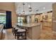 Open kitchen with granite countertops, large island with seating, and seamless transition to the living room at 6302 Anise Dr, Sarasota, FL 34238