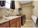 Functional laundry room with modern washer and dryer, granite countertop, and ample storage space at 6302 Anise Dr, Sarasota, FL 34238