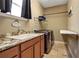 Functional laundry room with modern washer and dryer, granite countertop, and ample storage space at 6302 Anise Dr, Sarasota, FL 34238