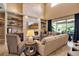 Bright living room with stone fireplace, built-in shelving, and plush seating at 6302 Anise Dr, Sarasota, FL 34238