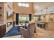 Open concept living room featuring a stone fireplace, tall ceilings, and seamless transition to the kitchen at 6302 Anise Dr, Sarasota, FL 34238