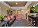 Comfortable living room with a brown leather sofa, large tv and neutral decor at 6302 Anise Dr, Sarasota, FL 34238