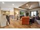 Open-concept living room with wood flooring, a cozy chair, and seamless flow to the staircase at 6302 Anise Dr, Sarasota, FL 34238