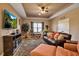Comfortable living room with a brown leather sofa, large tv and neutral decor at 6302 Anise Dr, Sarasota, FL 34238