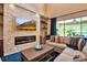 Comfortable living room features a stone accent wall with fireplace and seamless access to the outdoors at 6302 Anise Dr, Sarasota, FL 34238