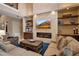 Living area with stone fireplace, built-in shelving, and large windows with backyard views at 6302 Anise Dr, Sarasota, FL 34238