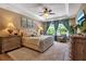 Serene main bedroom featuring tray ceilings, plush carpeting, and large windows with natural light at 6302 Anise Dr, Sarasota, FL 34238