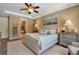 Spacious main bedroom with a tufted bed, sitting area and ensuite bathroom at 6302 Anise Dr, Sarasota, FL 34238
