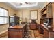 Well-appointed home office with custom desk, ample storage, and an elegant workspace at 6302 Anise Dr, Sarasota, FL 34238