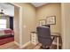 Office with desk and chair, adjacent to bedroom with red rug at 6302 Anise Dr, Sarasota, FL 34238
