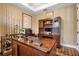 Traditional office features hardwood floors, built-in bookcase, and a large desk at 6302 Anise Dr, Sarasota, FL 34238