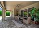 The elegant covered patio features a ceiling fan, outdoor dining area, and smooth flooring at 6302 Anise Dr, Sarasota, FL 34238
