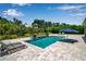 Beautiful pool with a waterfall feature and inviting lounge area for relaxation at 6302 Anise Dr, Sarasota, FL 34238