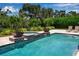 Pool and spa surrounded by lush landscaping and manicured yard at 6302 Anise Dr, Sarasota, FL 34238