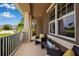 Comfortable front porch has wicker seating, accent pillows, and lovely natural light at 6302 Anise Dr, Sarasota, FL 34238