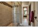 Glass-enclosed shower with mosaic tile accents and modern fixtures at 6302 Anise Dr, Sarasota, FL 34238