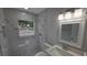 A modern bathroom featuring a tiled shower, decorative mirror, and a white marble floor at 6404 8Th Street W Ct, Bradenton, FL 34207