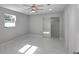 A bedroom with a ceiling fan, white marble floors, and mirrored closet doors at 6404 8Th Street W Ct, Bradenton, FL 34207