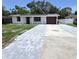 Charming single-story home with a brick-paved driveway and a one-car garage in a suburban neighborhood at 6404 8Th Street W Ct, Bradenton, FL 34207