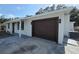 A single-story home with a modern one-car garage and a gray paver driveway at 6404 8Th Street W Ct, Bradenton, FL 34207