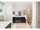 Spacious bathroom with a large vanity, glass-enclosed shower, and modern lighting at 650 Rosemary Cir, Bradenton, FL 34212