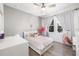 Bright bedroom with light gray walls, laminate flooring, and two windows with views to the backyard at 650 Rosemary Cir, Bradenton, FL 34212