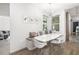 Modern dining area with a white table, stylish chairs, and a cozy built-in bench with pillows at 650 Rosemary Cir, Bradenton, FL 34212