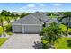 Charming single-story home boasting a three-car garage and well-maintained landscaping at 650 Rosemary Cir, Bradenton, FL 34212