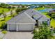 Beautiful single-Gathering home with a large gray roof, three-car garage, and well-manicured landscaping with a lake view at 650 Rosemary Cir, Bradenton, FL 34212