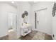 Bright foyer with modern decor, tile floors, a console table with mirrors, and a front door at 650 Rosemary Cir, Bradenton, FL 34212