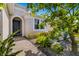 Inviting front entrance with arched entryway, landscaping, and brick pathway at 650 Rosemary Cir, Bradenton, FL 34212