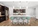 Modern kitchen with a large center island, stylish pendant lighting, and stainless steel appliances at 650 Rosemary Cir, Bradenton, FL 34212