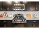 Close-up of the kitchen featuring stainless steel appliances, a gas range, and a white subway tile backsplash at 650 Rosemary Cir, Bradenton, FL 34212