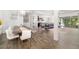 Open-concept living space featuring a dining area, living room, and kitchen with wood-look tile flooring at 650 Rosemary Cir, Bradenton, FL 34212