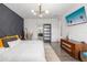 Bright main bedroom with a gray accent wall, modern lighting, and a glimpse into the bathroom at 650 Rosemary Cir, Bradenton, FL 34212