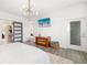 Well-lit main bedroom with a ceiling fan, decorative sliding door, and modern decor at 650 Rosemary Cir, Bradenton, FL 34212