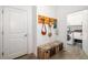 Mudroom/entryway featuring a decorative wall rack with hooks, a storage bench, and access to the laundry room at 650 Rosemary Cir, Bradenton, FL 34212