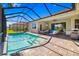 Stunning pool area featuring a screened enclosure, spacious deck, and comfortable seating at 650 Rosemary Cir, Bradenton, FL 34212