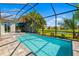 Screened-in pool with brick patio and view of the yard at 650 Rosemary Cir, Bradenton, FL 34212