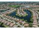 Aerial view of the community showcasing homes around a scenic lake, offering a peaceful neighborhood setting at 673 Crane Prairie Way, Osprey, FL 34229