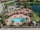 Community center with pool, lounge chairs, and palm trees offering a resort-style experience at 673 Crane Prairie Way, Osprey, FL 34229