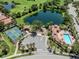 Aerial view of amenities including a playground, pool, and tennis courts in a community setting at 673 Crane Prairie Way, Osprey, FL 34229