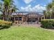 Landscaped backyard features a screened-in pool, patio, and lush green grass at 673 Crane Prairie Way, Osprey, FL 34229