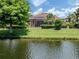 Beautiful backyard with a screened-in porch overlooking a well-maintained lawn and serene lake at 673 Crane Prairie Way, Osprey, FL 34229