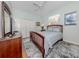 Cozy bedroom with a wooden bed frame, a closet, and a window with natural light at 673 Crane Prairie Way, Osprey, FL 34229