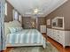 Comfortable bedroom with a wooden bed frame and neutral-toned walls with an ensuite at 673 Crane Prairie Way, Osprey, FL 34229